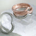 Stack of rose gold chevron rings with millgrain and white gold diamond band