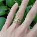 Rose gold diamond wedding band stacked with yellow gold rings on hand