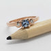 Rose gold engagement ring with blue asscher cut Montana sapphire and bezel set diamonds