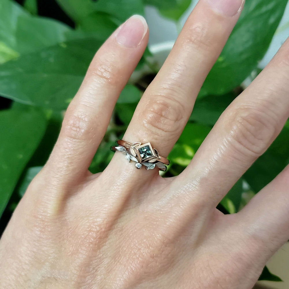 14kt rose gold green sapphire ring stacked with a white gold leaf band on hand