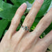 14kt rose gold green sapphire ring stacked with a white gold leaf band on hand