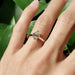 14kt rose gold oval lab diamond solitaire ring worn on hand in natural light