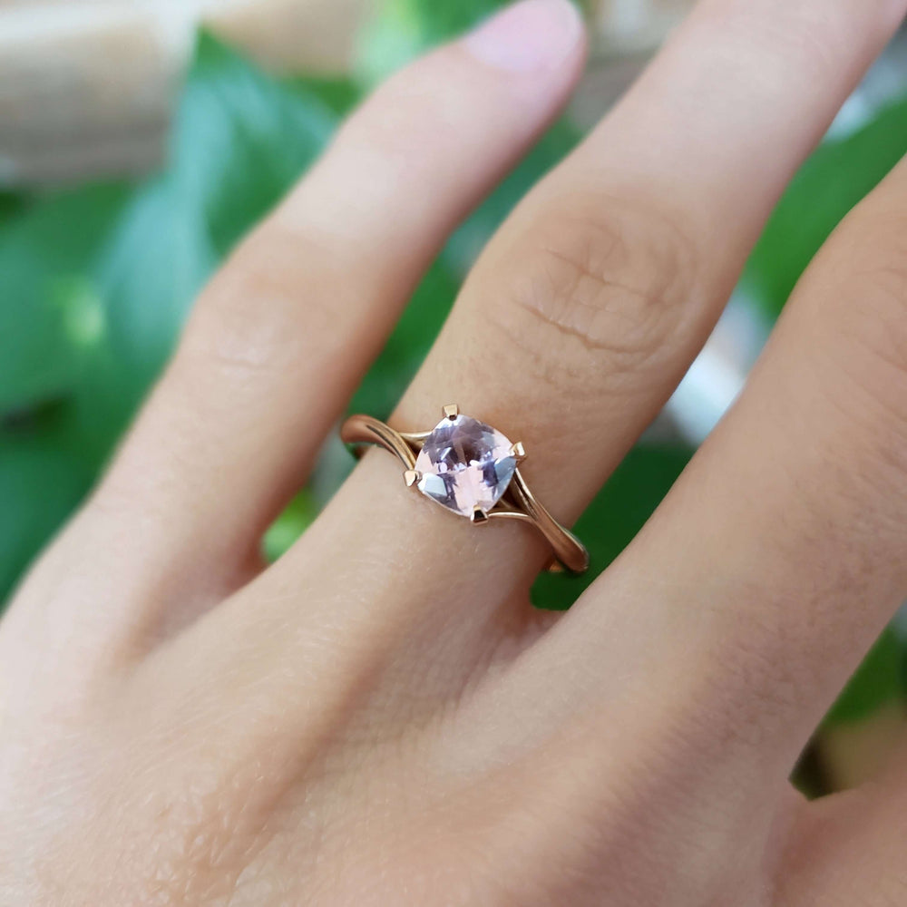 Rose gold pink sapphire engagement ring worn on hand