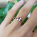Rose gold pink sapphire engagement ring worn on hand