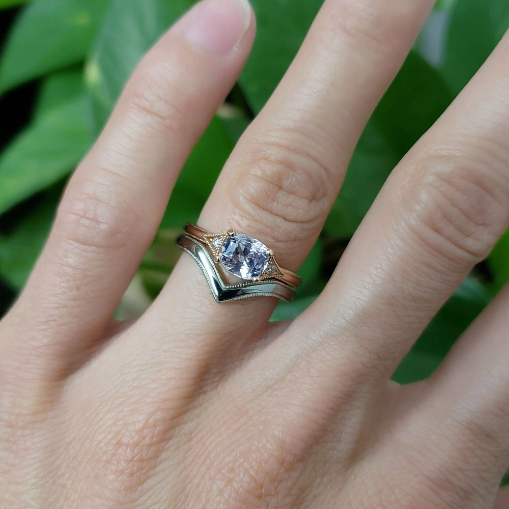 Rose gold pink sapphire ring stacked with a chevron band on hand