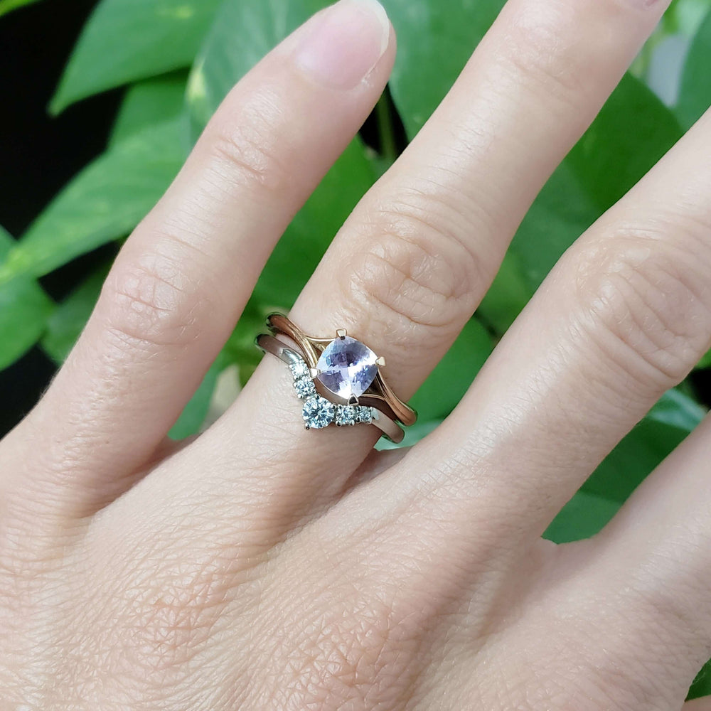 Rose gold pink sapphire ring stacked with diamond chevron band on hand