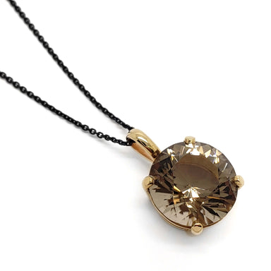 Round smoky quartz pendant in 14kt yellow gold on black chain, close-up view