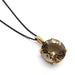 Round smoky quartz pendant in 14kt yellow gold on black chain, close-up view