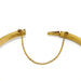 Detail of safety chain and hallmarks on open antique 15kt gold bangle