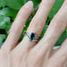 Sapphire and diamond engagement ring in white gold stacked with engraved band on hand
