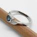 Side view of white gold Montana sapphire leaf ring on a pencil