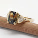 Side angle of bi-coloured sapphire and trillion diamond ring in 14kt yellow gold