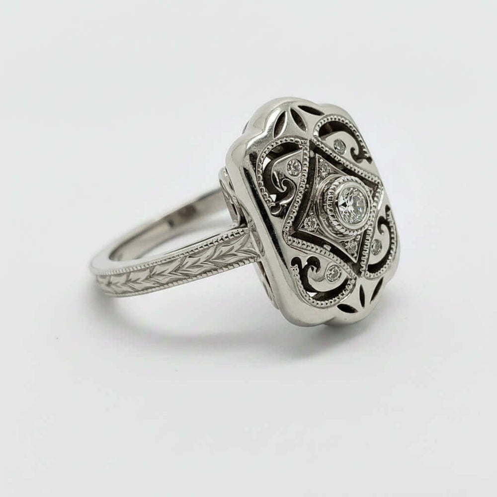 Side angle of engraved Edwardian diamond ring in white gold