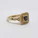 Side angle of handcrafted yellow gold ring with Montana sapphire and pavé diamonds