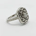 Side angle of white gold Edwardian engagement ring with diamond center and ornate engraving