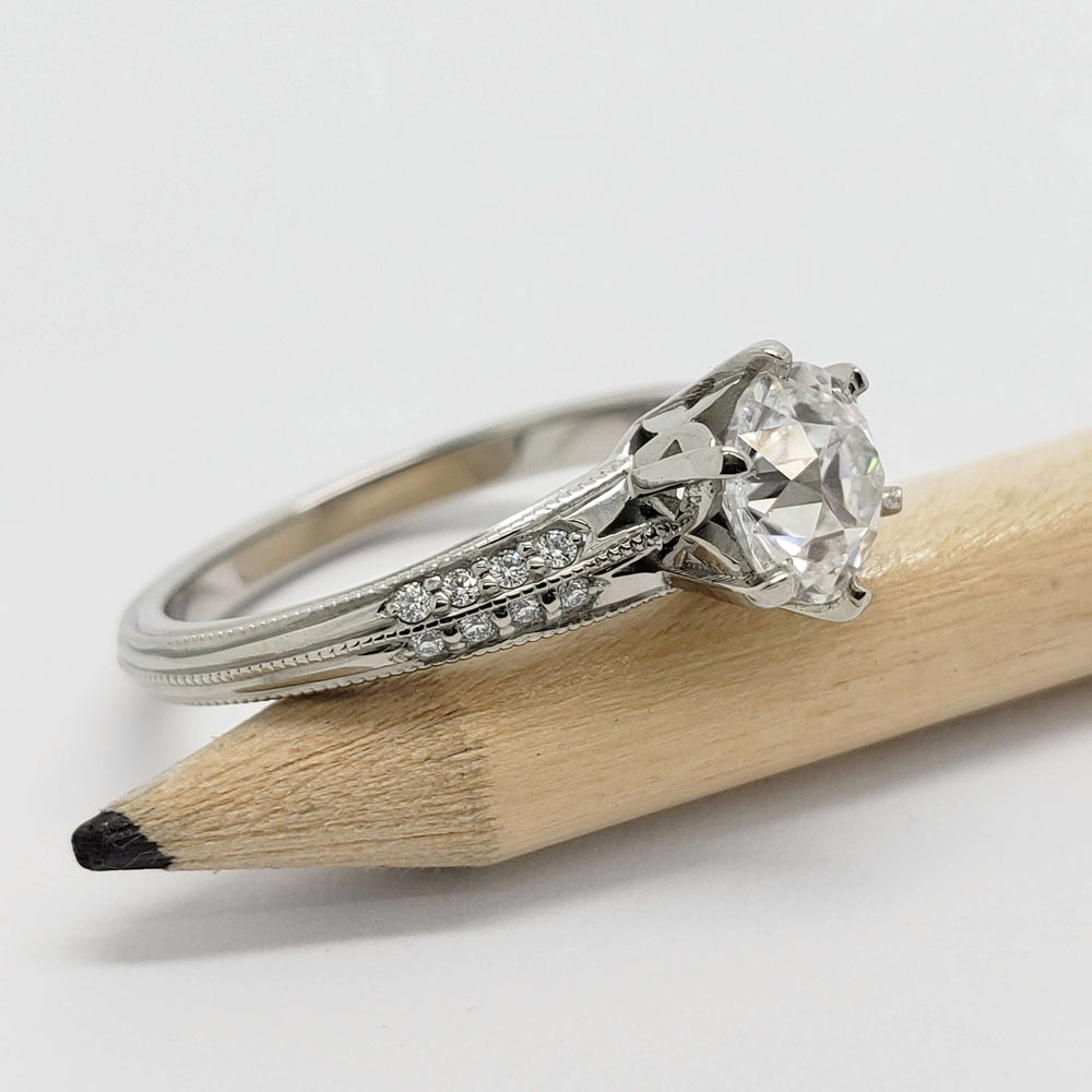 Side view of white gold engagement ring with moissanite and pave-set Canadian diamonds
