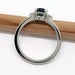 Side view of 14kt white gold Montana sapphire and diamond ring on white background