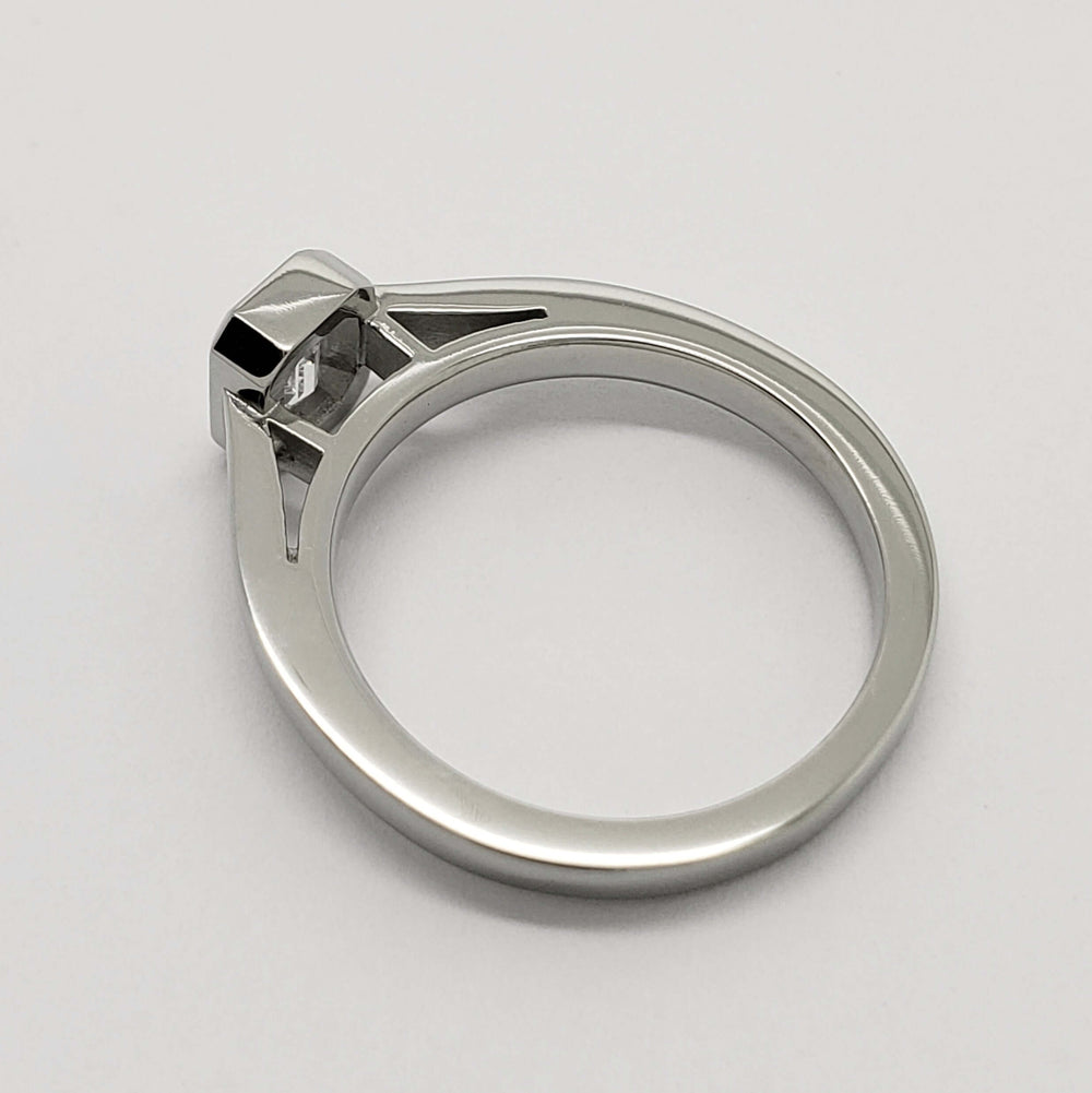 Side profile of 14kt white gold engagement ring with emerald cut lab diamond