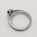Side profile of 14kt white gold engagement ring with emerald cut lab diamond