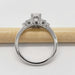 Side view of 14kt white gold oval lab diamond ring with accent stones on a pencil
