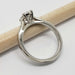 Side profile of 14kt white gold oval lab diamond ring with pave band, next to pencil