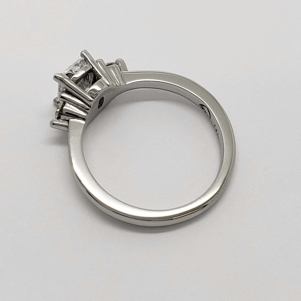 Side profile of 14kt white gold ring with cushion cut lab diamond and round side stones
