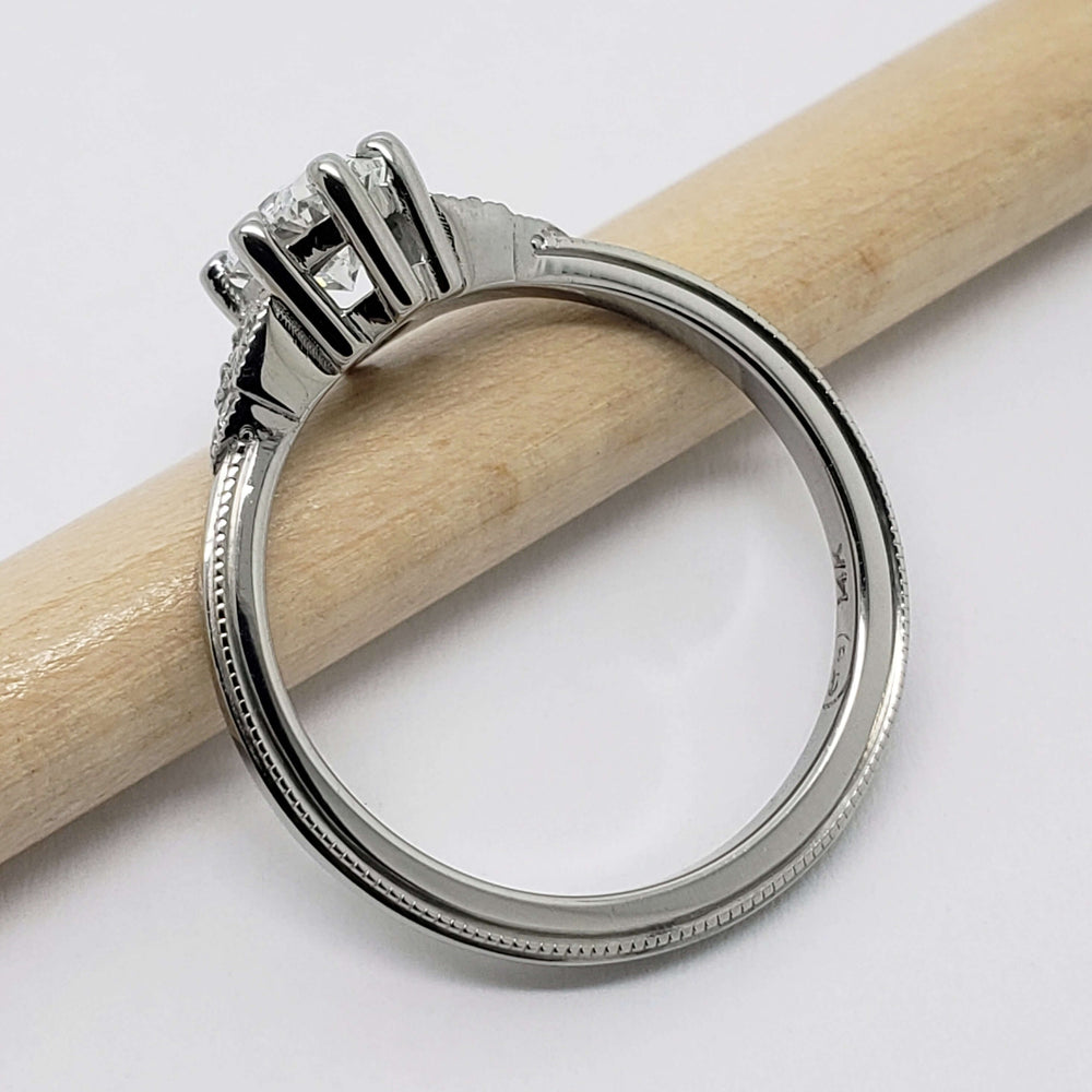Side profile of 14kt white gold ring with oval lab diamond and detailed band
