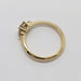 Side profile of 14kt yellow gold diamond engagement ring showing prong setting and band
