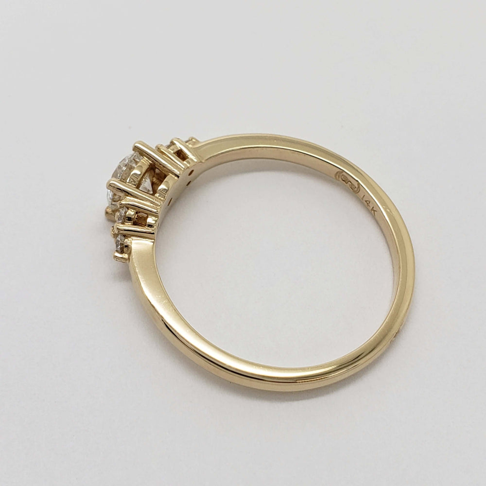 Side profile of 14kt yellow gold diamond ring showing setting details