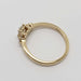 Side profile of 14kt yellow gold diamond ring showing setting details