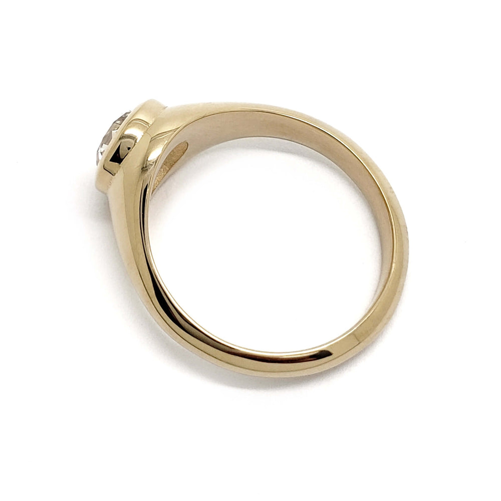 Side profile of 14kt yellow gold engagement ring with bezel-set lab diamond
