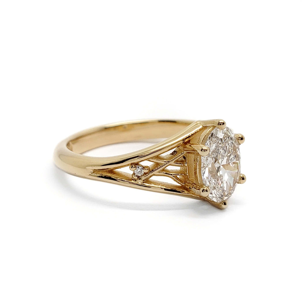 Side profile of 14kt yellow gold engagement ring with oval lab diamond