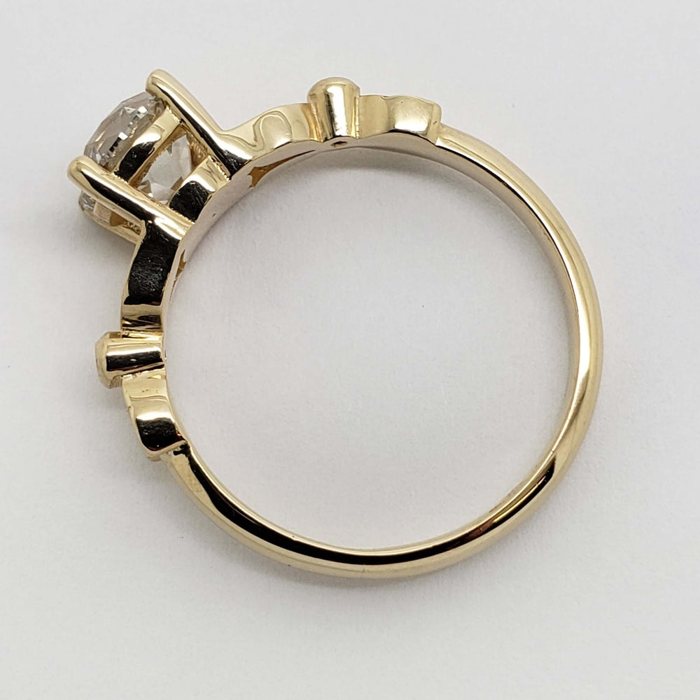 Side profile of 14kt yellow gold engagement ring with raised lab-grown diamond setting