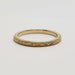 Side view of engraved 14kt yellow gold wedding band with millgrain detail