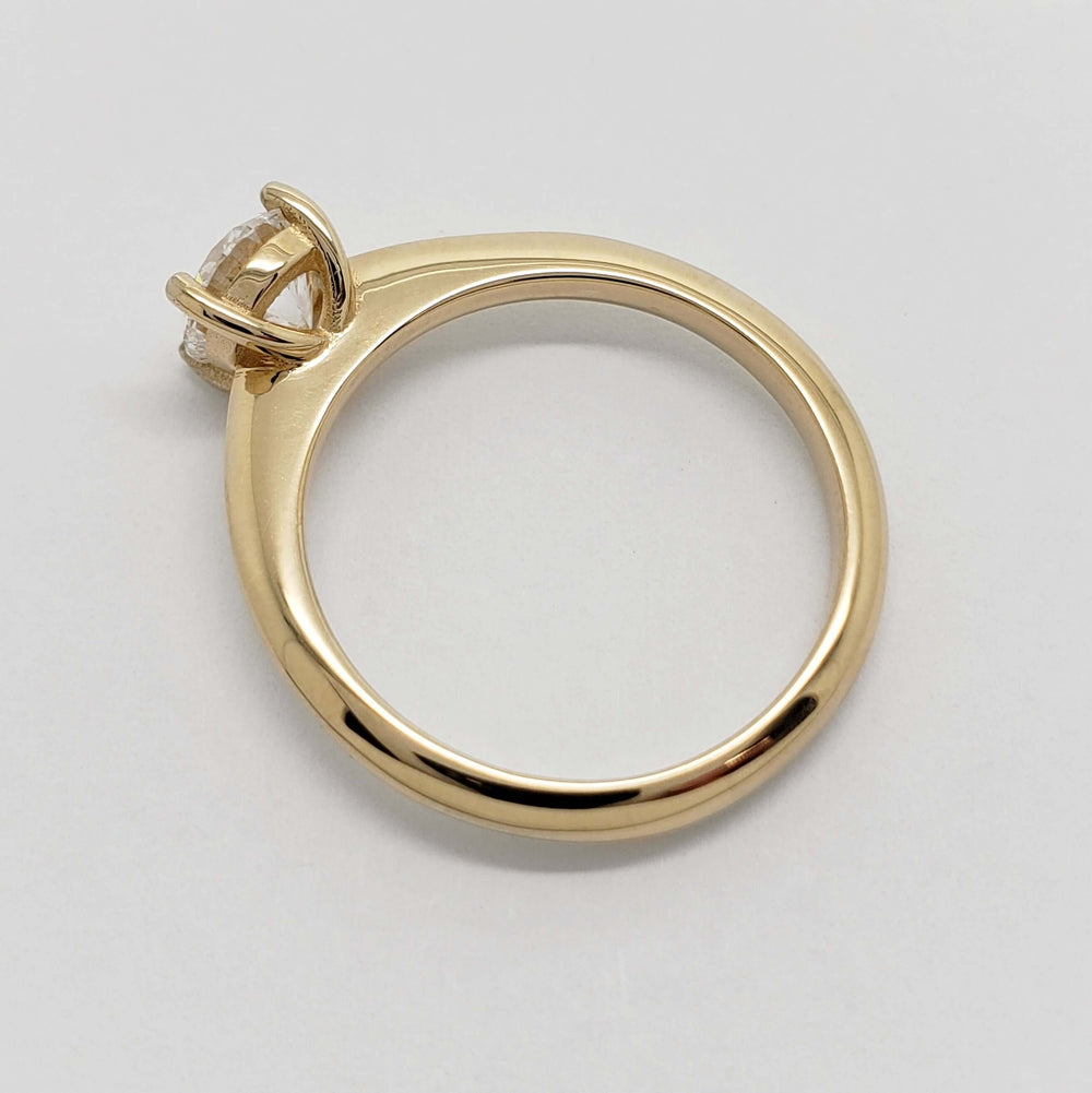 Side profile of 14kt yellow gold ring with four-claw lab diamond setting