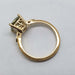 Side profile of 14kt yellow gold ring with green sapphire and detailed millgrain band
