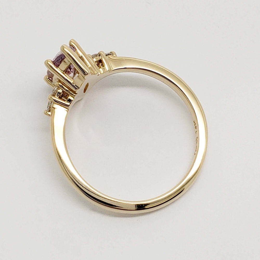 Side profile of 14kt yellow gold ring with marquise cut purple sapphire