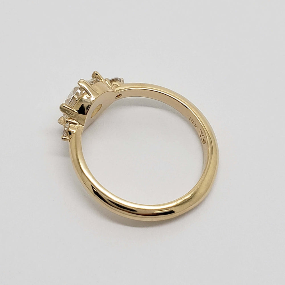 Side profile of 14kt yellow gold ring with rose cut lab diamond and two accent diamonds