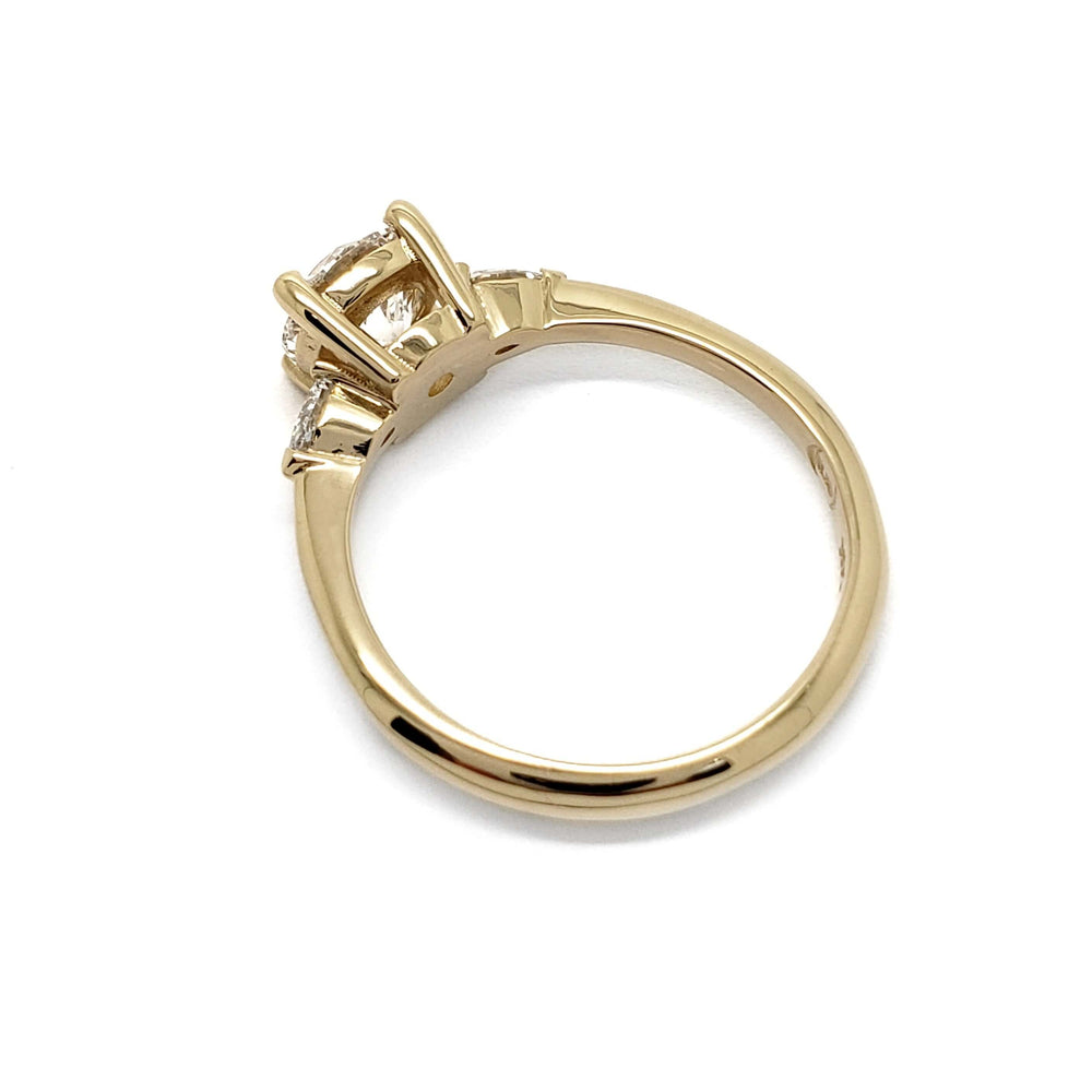 Side profile of 14kt yellow gold ring with round lab diamond and pear-shaped side stones