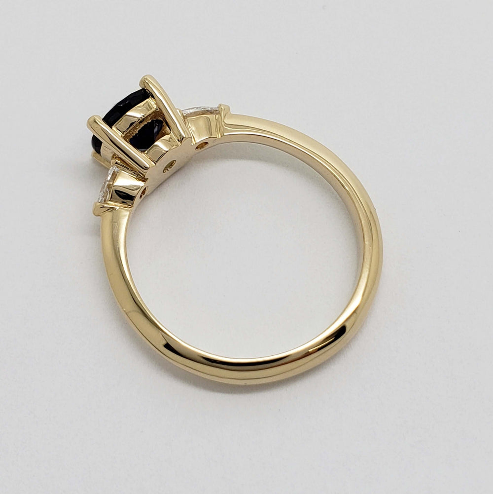 Side view of yellow gold ring band and setting for sapphire and lab diamonds