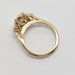Side view of 14kt yellow gold engagement ring with three lab-grown diamonds