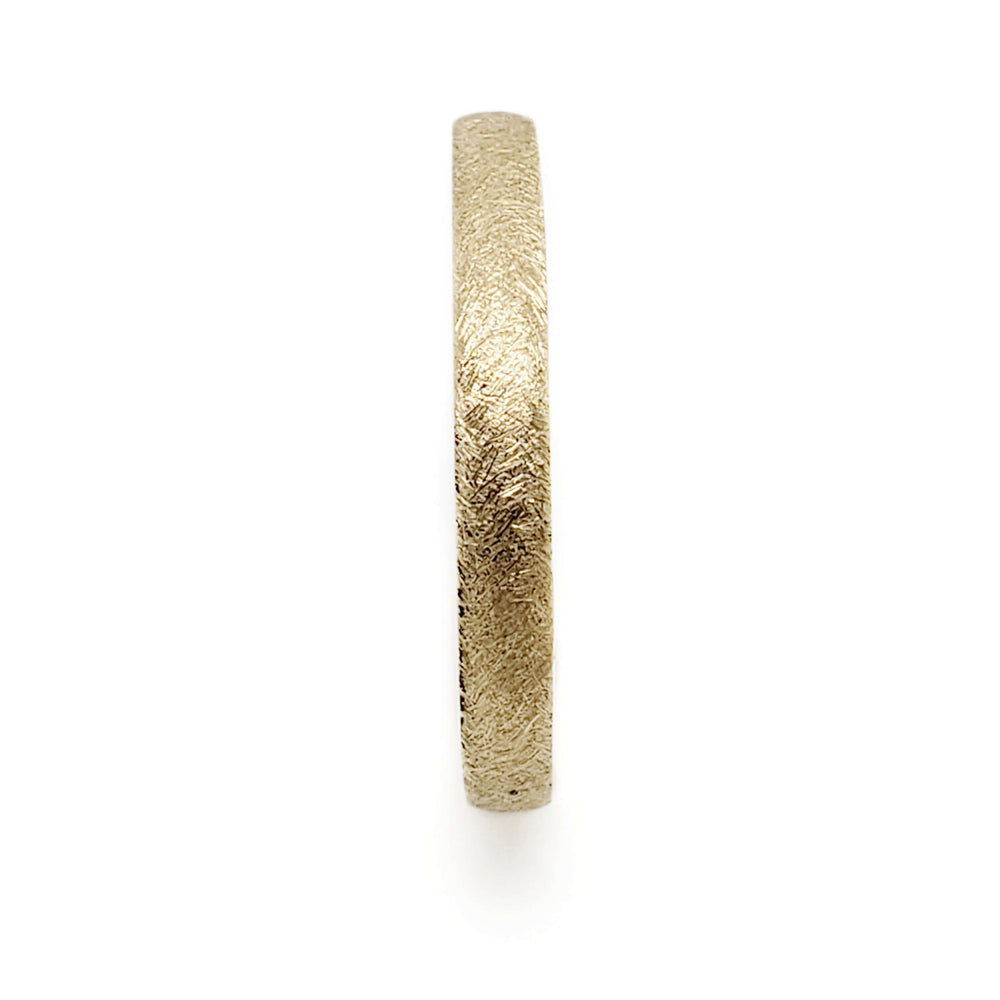 Side profile of 14kt yellow gold wedding ring showing textured finish