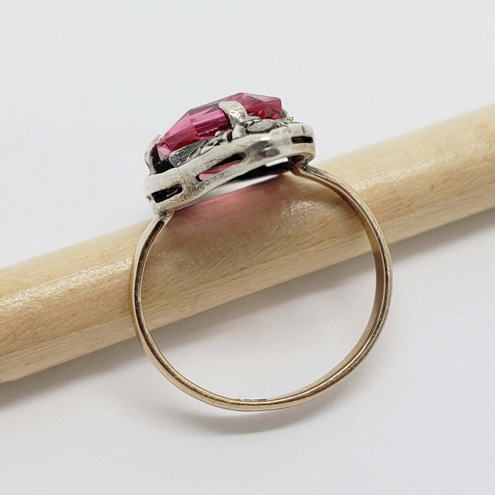 Side view of 9kt gold and silver ring with pink synthetic sapphire and marcasite setting