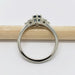 Side view of 14k white gold ring with Montana sapphire and diamonds on a pencil