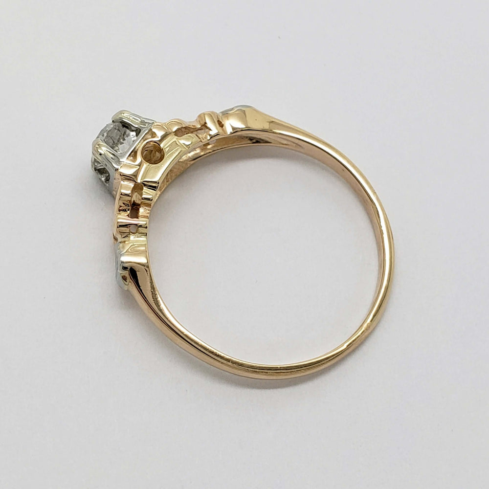 Side profile of antique floral diamond ring showing yellow gold band and white gold setting