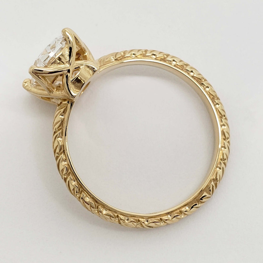 Profile of engraved 14kt yellow gold ring with cushion cut lab diamond setting