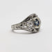 Side view of engraved 14kt white gold ring with blue sapphire and round diamonds