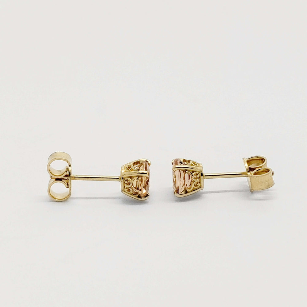 Side view of 14kt yellow gold filigree stud earrings with round imperial topaz