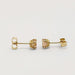 Side view of 14kt yellow gold filigree stud earrings with round imperial topaz