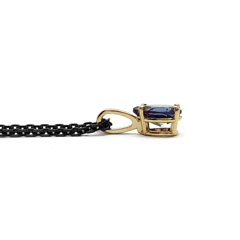 Side view of 14kt yellow gold pendant with pear cut lab alexandrite on black chain